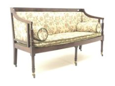 Regency mahogany framed settee, upholstered in a beige ground floral patterned fabric,