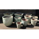 Six graduating square tapering glazed ceramic planters, five egg pots,