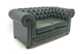 Two seat Chesterfield sofa, upholstered in deep buttoned green leather, bun feet,