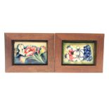 Two Moorcroft framed rectangular box lids decorated with floral sprays,