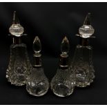 Two pairs of cut glass and silver mounted scent bottles,