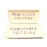 Two Moorcroft Pottery rectangular advertising trays, 20.