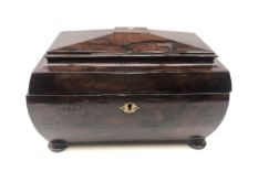 19th century mahogany tea caddy of sarcophagus form on bun feet,