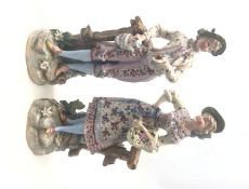 Pair 19th century Ernst Bohne Sohne porcelain figures of a gentleman courting a young lady holding