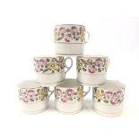 Set of six early 19th century English porcelain coffee cans decorated with pink and yellow flowers