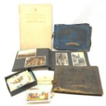 Three photograph albums containing Edwardian and later postcards and photographs including RP and