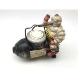 Replica cast iron Michelin Man advertising figure seated on a compressor L21cm