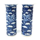 Pair of late 19th/early 20th century Chinese cylindrical vases each decorated with dragons chasing