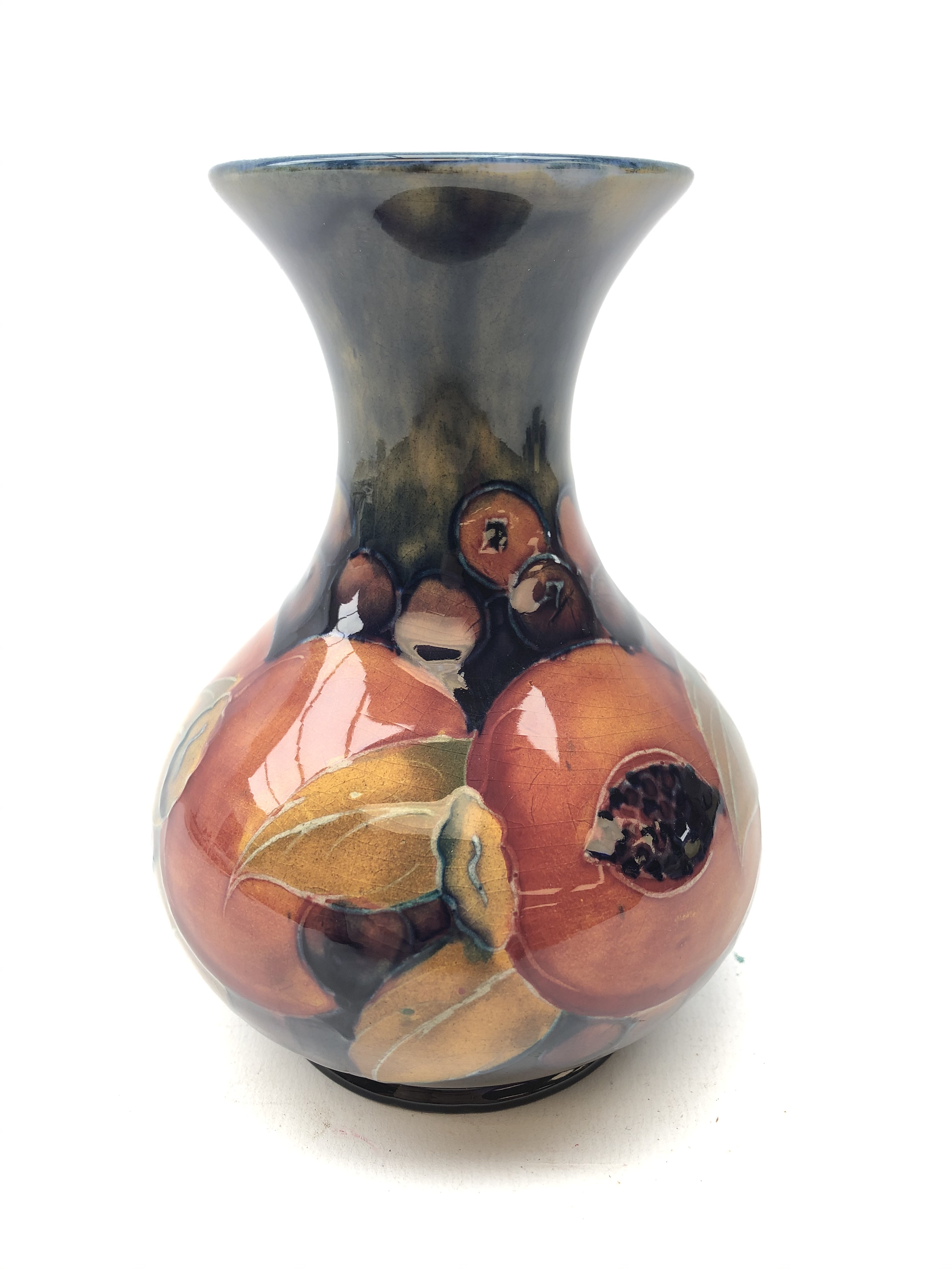 William Moorcroft Pomegranate pattern baluster vase with flared rim, c1920 H13.