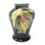 William Moorcroft Leaf & Berry pattern miniature vase of baluster form c1930 H9.