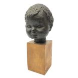 20th century bronze head of a child on wooden base, indistinctly signed in pencil,