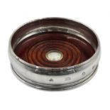 Silver wine coaster with turned mahogany base by A Haviland-Nye,