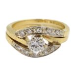 Two gold rings, one set with a round brilliant cut diamond and diamond shoulders,