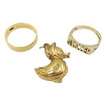 Gold wedding band, stamped 18ct, gold duck charm and a gold 'sister' ring,