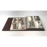 Modern loose leaf album containing over two hundred and seventy Edwardian and later postcards of