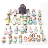 Collection thirty of ceramic pin cushion/ half dolls of varying sizes,