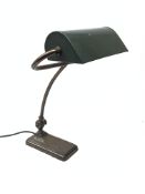 Art Deco bankers desk lamp, steel base and pivoted sweeping arm supporting a green metal shade,