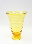 Amber glass Whitefriars style footed vase with ribbed body,