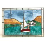 Leaded stained glass panel of a sailing boat off the coast,
