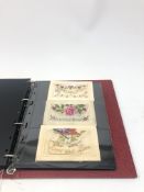 Modern loose leaf album containing over fifty WW1 silk postcards including Regimental crests,
