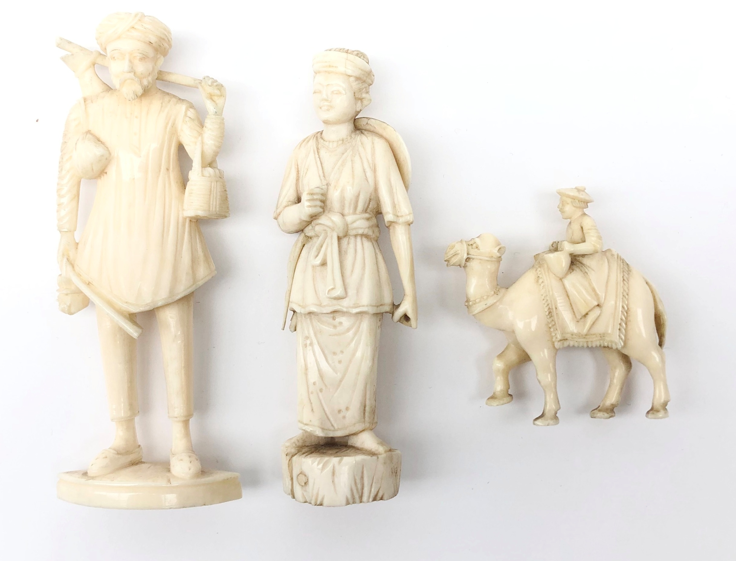 19th/ early 20th century matched pair Indian ivory figures and a similar age ivory carving of a