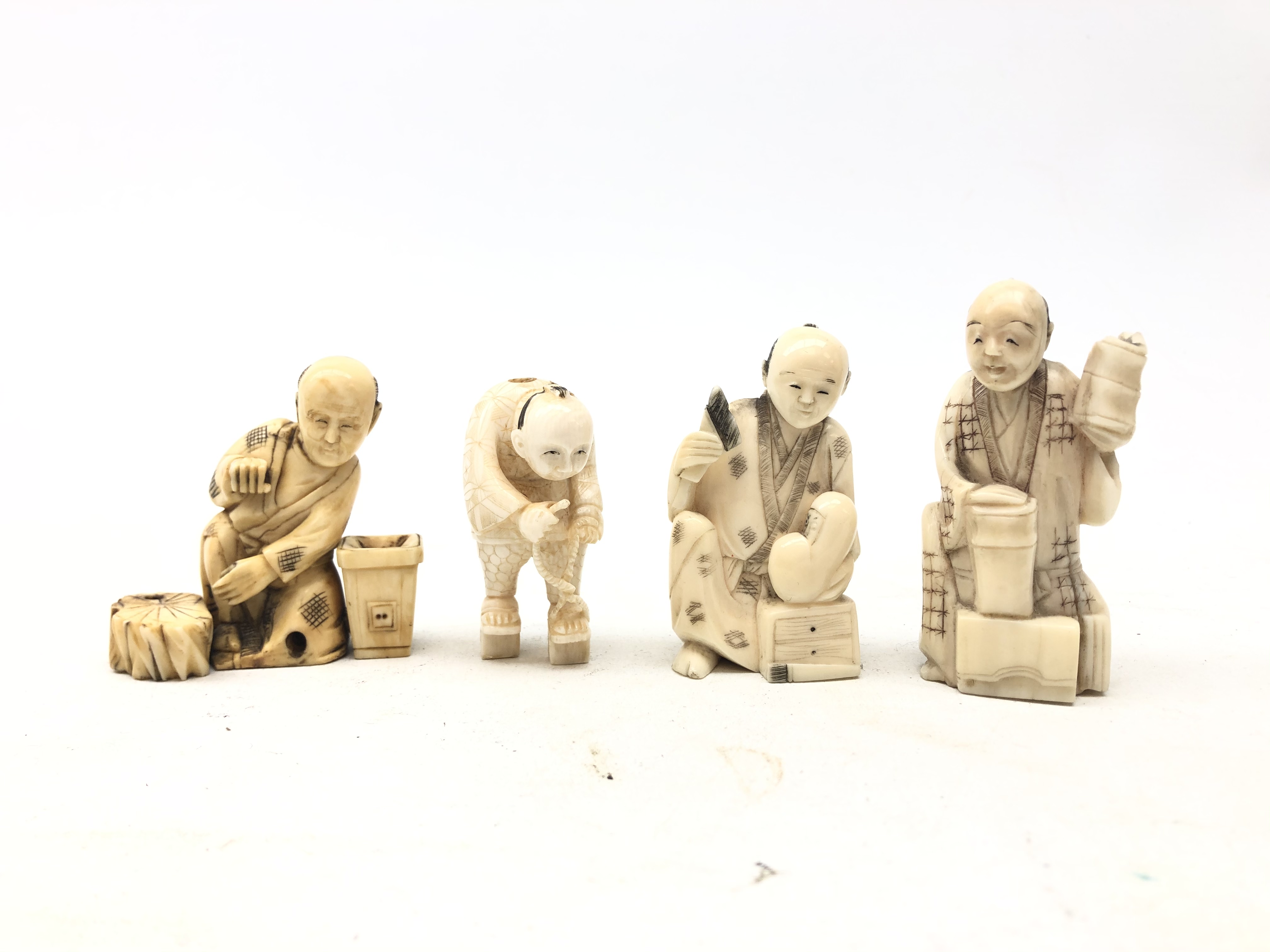 Group of four Japanese Meiji ivory Okimonos carved as crafts men,