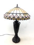 Tiffany style table lamp on urn shaped base with leaded glass and beaded shade,