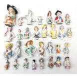 Collection of thirty ceramic pin cushion/ half dolls of varying size H11cm max Condition