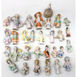Collection thirty of ceramic pin cushion/ half dolls of varying sizes,