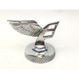 Reproduction Bentley chrome mascot on circular base,