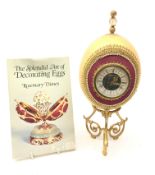 Ostrich egg mantle clock with beaded and gilt thread embellishment,