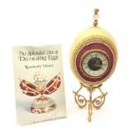 Ostrich egg mantle clock with beaded and gilt thread embellishment,