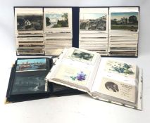 Three modern albums containing a total of over four hundred and fifty Edwardian and later postcards,