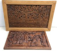 20th century African wooden panel depicting figures dancing and a similar panel on fretwork ground,