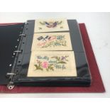 Modern loose leaf album containing over fifty WW1 silk postcards including flags of the Allies,