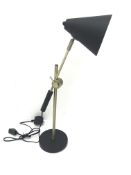 Brass and black finish adjustable desk lamp with cone shaped shade, on circular base,