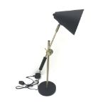 Brass and black finish adjustable desk lamp with cone shaped shade, on circular base,