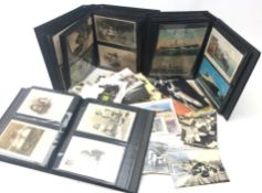 Large quantity of Edwardian and later postcards, loose and in a modern slipcase of three albums,