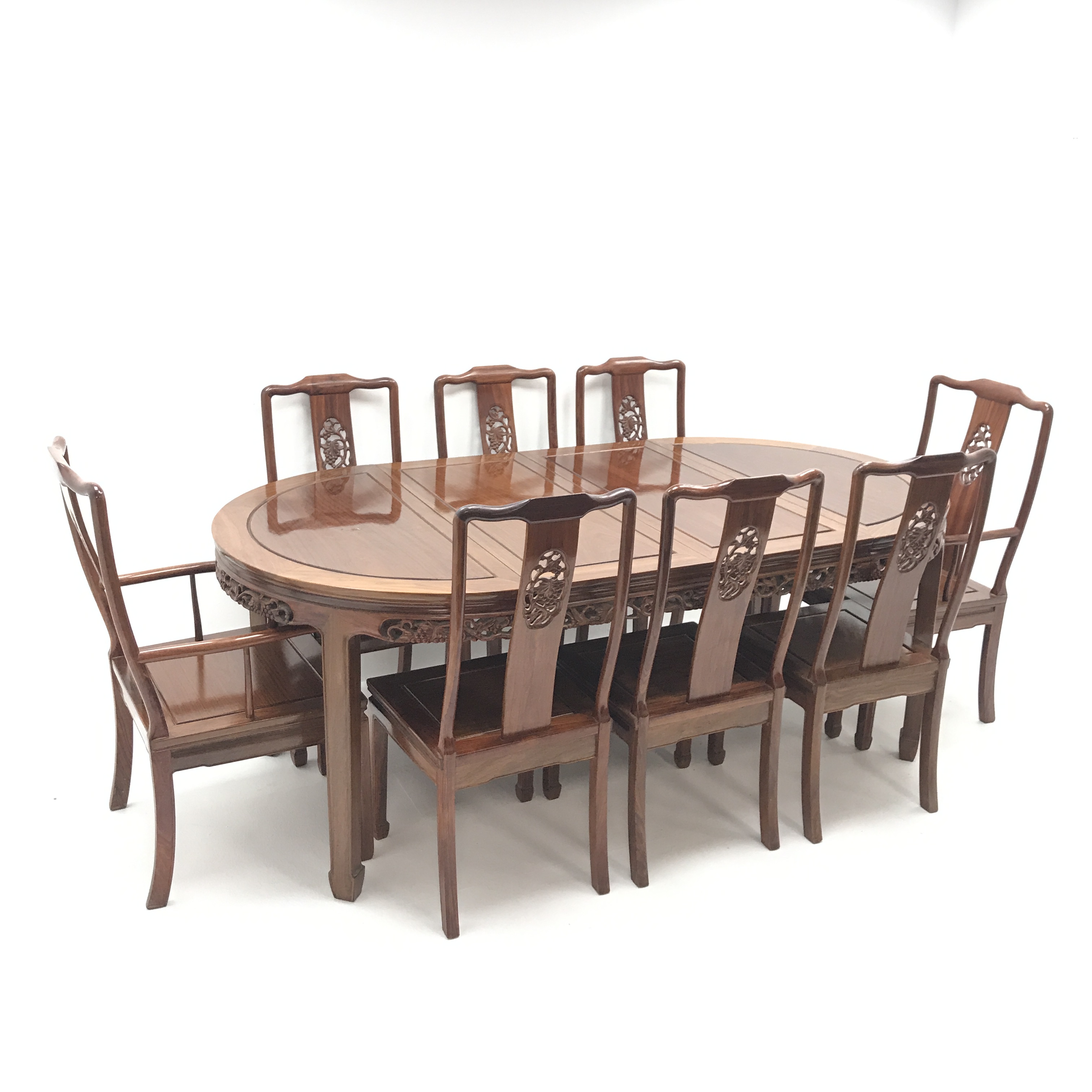 Chinese hardwood extending dining table with two leaves, pierced apron,