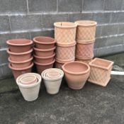 Twenty nine pots comprising of eleven terracotta cylindrical pots with lattice design (maximum