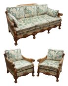 Early 20th century walnut framed bergere suite, the acanthus carved outsplayed arms