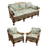 Early 20th century walnut framed bergere suite, the acanthus carved outsplayed arms