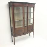 Edwardian inlaid mahogany shaped front display cabinet, projecting cornice,