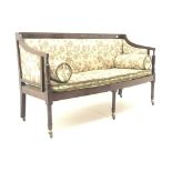 Regency mahogany framed settee, upholstered in a beige ground floral patterned fabric,