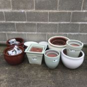 Twelve graduating glazed ceramic belly pots and six other pots (18)