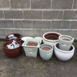 Twelve graduating glazed ceramic belly pots and six other pots (18)