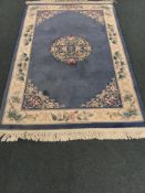 Chinese blue ground rug, central medallion, repeating border,