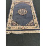 Chinese blue ground rug, central medallion, repeating border,