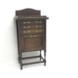 Early 20th century oak cabinet, raised shaped back three drawers above single fall front, W52cm,