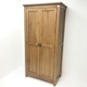 Modern oak double wardrobe, projecting cornice, two doors enclosing hanging rail, stile supports,